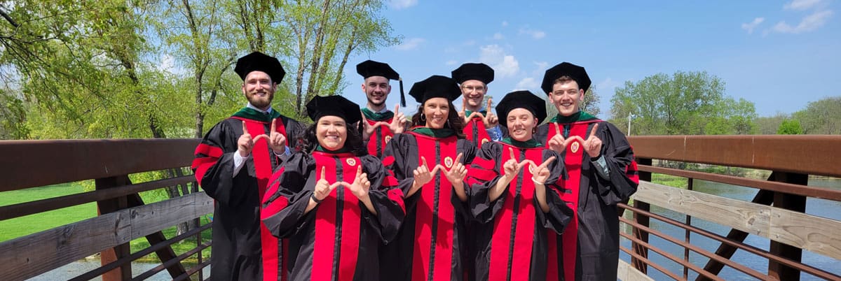 Graduation 2022 - WARM Students stand on a bridge