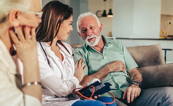 A young doctor during a home visit with seniors