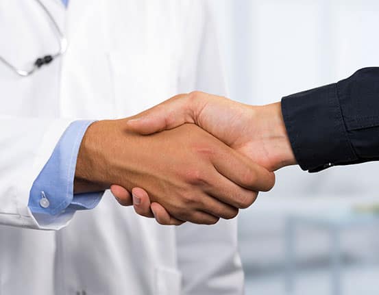 RuralWorkforceRecruitment A rheumatologist examines hand joints on an x-ray