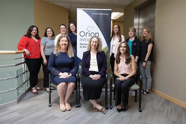 Orion Initiative Program Launch 2025 The Orion Initiative team smiles for the camera in front of an Orion Initiative banner